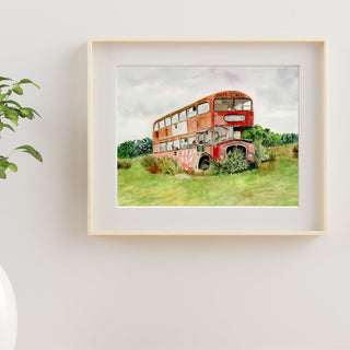 Photo of an original, hand-painted watercolor painting of a United Kingdom red bus in a field.